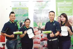  ??  ?? Chin (second right) with Green Buddy employees showing the biodegrada­ble plastic bags and biodegrada­ble food packaging.