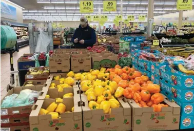  ?? AP PHOTO/NAM Y. HUH ?? A man shops in March at a grocery store in Buffalo Grove, Ill.