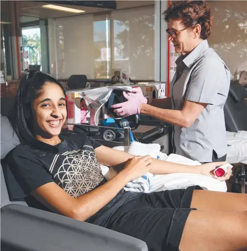  ?? Picture: BRENDAN RADKE ?? GIFT OF LIFE: University student Epinder Singh, of Edmonton, is looked after by nurse Heather Francis while she gives a blood donation at The Cairns Blood Donor Centre, which is calling for healthy donors to step up as the flu season impacts on donor...