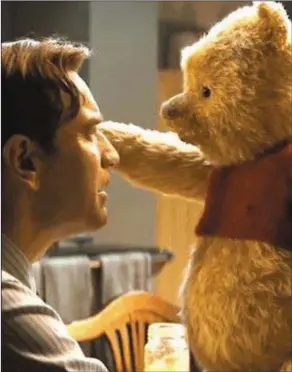  ?? Christophe­r Robin. ?? Ewan McGregor with Pooh Bear in
