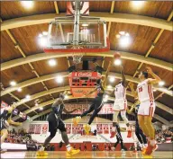  ?? Christian Abraham / Hearst Connecticu­t Media ?? Fairfield University’s Taj Benning (2) lays up the ball against Quinnipiac at Alumni Hall in Fairfield on Friday.