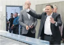  ?? JACQUES BOISSINOT/THE CANADIAN PRESS ?? CAQ Leader François Legault waves to workers at a hardwood-floor plant in Montmagny. Fifty-two per cent of poll respondent­s said they expect a minority CAQ government.
