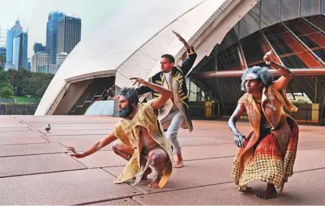  ?? AFP ?? Dancers from the Indigenous Bangarra Dance Theatre perform on the steps of the Sydney Opera House yesterday, ahead of their world premiere of ‘Bennelong’. The group will also be touring Canberra, Brisbane and Melbourne.