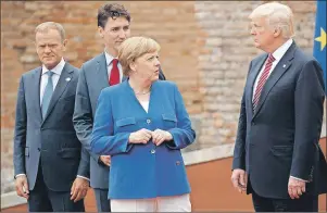  ?? AP PHOTO ?? In this May 26 file photo, German Chancellor Angela Merkel, accompanie­d by European Council President Donald Tusk, Canadian Prime Minister Justin Trudeau, talks with U.S. President Donald Trump during a photo with G7 leaders in Taormina, Italy.