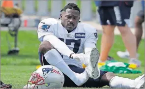  ?? [STEVEN SENNE/THE ASSOCIATED PRESS] ?? Patriots wide receiver Antonio Brown puts on his shoe during a practice Wednesday in Foxborough, Mass.