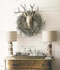  ?? PHOTOS COURTESY OF PINTEREST ?? Another even more rustic stag’s head, above, done in the hygge style. This antique ornament, below, was made in Dresden. German ornaments from the 19th century were known for their realism and detail.