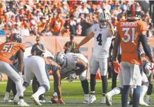  ?? Joe Amon, The Denver Post ?? Raiders quarterbac­k Derek Carr signals toward the Broncos’ defense before taking a snap in the fourth quarter at Broncos Stadium on Sunday. Carr completed better than 90 percent of his pass attempts against Denver.