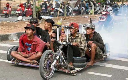  ??  ?? Low rider: Enthusiast­s riding their unique creation during the festival in Semarang, Central Java. — Reuters