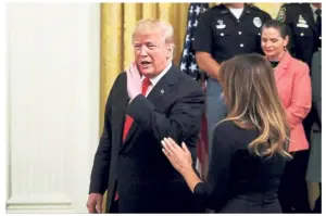  ?? — Reuters ?? Said his piece: Trump departing the East Room with First Lady Melania Trump after speaking about the pipe bomb packages.