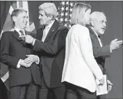  ?? Jean-Christophe Bott
European Pressphoto Agency ?? JOHN F. KERRY, second from left, and other diplomats gather for an announceme­nt after nuclear talks.