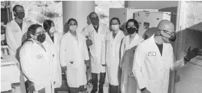  ??  ?? Intervenn CEO and founder Aldo Carrascoso inspect the lab's cryogenic machine that keeps the samples taken from patients safe and secure for data gathering.