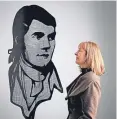  ?? Picture: PA. ?? Curator Sheilagh Tennant with a portrait of Robert Burns at the Summerhall, Edinburgh.
