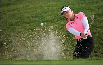  ?? STUART FRANKLIN — GETTY IMAGES ?? Brooke Henderson plays a shot from a bunker during her second consecutiv­e 64 in the Evian Championsh­ip on Friday.