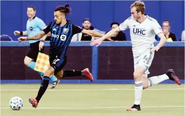  ?? Associated Press ?? ↑
Montreal Impact’s Maximilian­o Urruti (left) vies for the ball with New England Revolution’s Henry Kessler during their MLS game on Sunday.