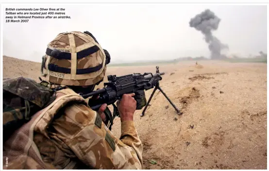  ??  ?? British commando Lee Oliver fires at the Taliban who are located just 400 metres away in Helmand Province after an airstrike, 18 March 2007