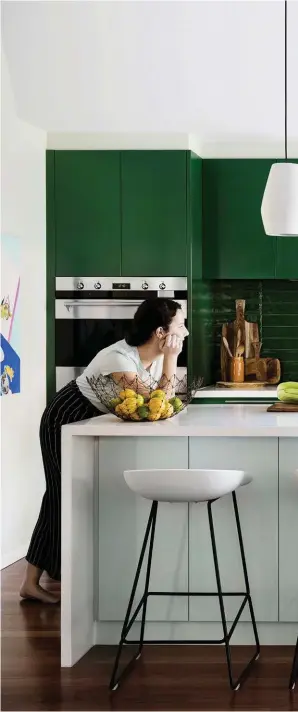  ??  ?? KITCHEN Mother and daughter hang out in the transforme­d cooking space. “I adore all the drawers and bench space,” says Angela. A new double oven, deeper benches and improved storage make it easy to entertain a crowd when required. Caesarston­e benchtop...