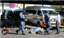  ?? PICTURE: TRACEY ADAMS/AFRICAN NEWS AGENCY (ANA) ?? TAXI WAR CASUALTIES: Police gather evidence following the twin deaths of taxi drivers at 8am yesterday.