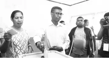  ??  ?? Conceicao from the Democratic Party casts his ballot during the presidenti­al election at a polling station in Dili. — Reuters photo