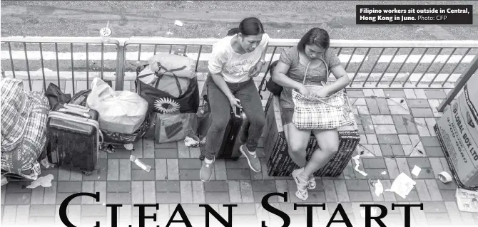  ?? Photo: CFP ?? Filipino workers sit outside in Central, Hong Kong in June.