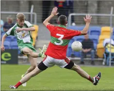  ??  ?? Baltinglas­s’s Adam McHugh fires past Rathnew’s Damien Power.