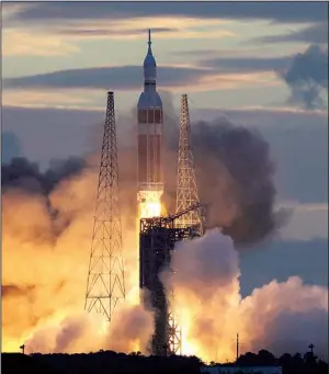  ?? AP/MARTA LAVANDIER ?? The Orion spacecraft lifts off Friday at Cape Canaveral, Fla., on its first test flight, marking the beginning of a “new era of American space exploratio­n,” a NASA spokesman said.