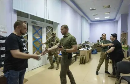  ?? Nariman El-mofty / Associated Press ?? Donetsk governor Pavlo Kyrylenko, center, leaves after holding a joint interview for The Associated Press and Reuters in Kramatorsk, Ukraine, on Tuesday.