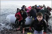  ?? MICHAEL VARAKLAS — THE ASSOCIATED PRESS ?? Migrants arrive at the village of Skala Sikaminias, on the Greek island of Lesbos, after crossing on a dinghy the Aegean sea from Turkey on Monday.