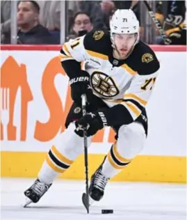  ?? GETTY IMAGES PHOTOS ?? Rookie Connor Bedard (left) and veteran Taylor Hall (above, with the Bruins) have clicked as linemates in the early days of training camp.