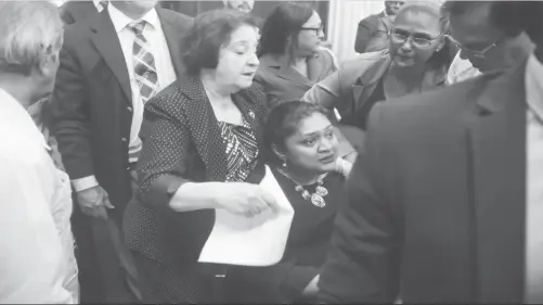  ??  ?? PPP/C MP Priya Manickchan­d being consoled yesterday after the confrontat­ion with the police in Parliament Chambers.