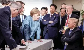  ??  ?? Angela Merkel, the German chancellor, speaks to Donald Trump during the G7 meeting in Quebec, 2018. Photograph: Reuters