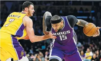  ?? THE ASSOCIATED PRESS ?? The Sacramento Kings’ DeMarcus Cousins, right, drives past the Los Angeles Lakers’ Larry Nance Jr. during a game ;ast week in Los Angeles. The Kings have agreed to trade Cousins and Omri Casspi to the New Orleans Pelicans in exchange for Tyreke Evans,...