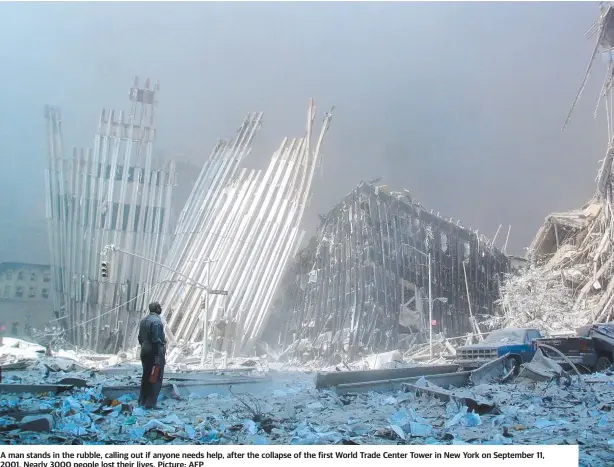  ?? Picture: AFP ?? A man stands in the rubble, calling out if anyone needs help, after the collapse of the first World Trade Center Tower in New York on September 11, 2001. Nearly 3000 people lost their lives.