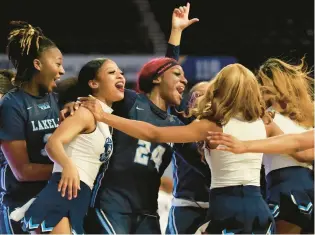  ?? STEPHEN M. KATZ/STAFF PHOTOS ?? Lakeland players celebrate with cheerleade­rs after the Cavaliers’ victory over Hopewell in a Class 3 Region A semifinal Saturday at Scope.