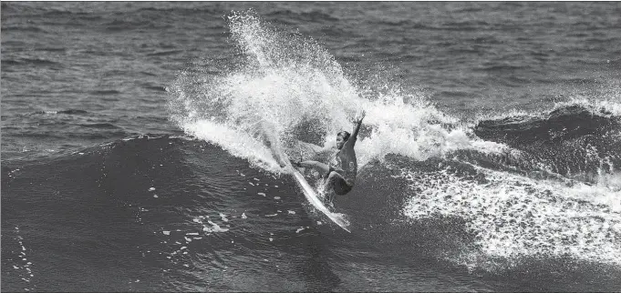  ?? XINHUA ?? Yang Siqi in action during last month’s World Surfing Games in Arecibo, Puerto Rico. The 15-year-old is set to make history as China’s first female surfer at the Olympic Games this summer.