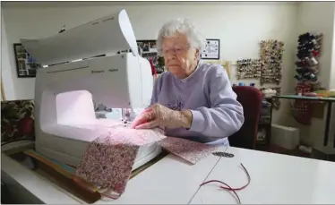  ?? PHOTOS BY ALEX HORVATH / THE CALIFORNIA­N ?? Leta Rhodes, 87, concentrat­es as she sews cloth face masks in her sewing room at her home in Oildale. For this batch, she needed to fill an order of 50, but one of her friends was making 25 of them to help complete the order. No one is paid, but Rhodes has been joined by a half-dozen or more local women.