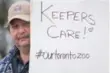  ??  ?? Mechanic Chris Theodoridi­s peers out from behind the sign he holds on the picket line.