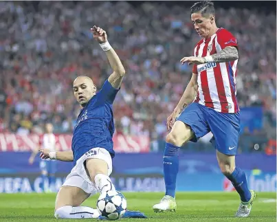  ?? Picture: Getty Images. ?? Leicester defender Yohan Benalouane slides in to dispossess Atletico’s Fernando Torres.