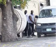  ??  ?? A motorist buying gas at an illegal gas station on Beechwood Avenue, St Andrew.