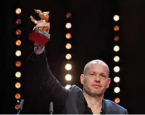  ??  ?? Israeli director Nadav Lapid celebrates with his Golden bear for best film for “Synonyms” during the awards ceremony of the 69th Berlinale film festival. — AFP photos