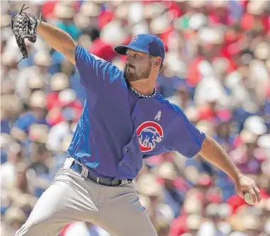  ?? | H. RUMPH JR./AP ?? Travis Wood took a no-hitter into the sixth inning and threw eight scoreless innings Sunday in Philadelph­ia.