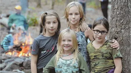  ?? STAFF PHOTO BY CHRISTOPHE­R EVANS ?? THEY’RE PREPARED: Boston area youngsters, from left, Maia Stark, 11, Hailey MacDougall, 7, Ocean Farinella, 9, and Giulia Stark, 8, at the Boy Scouts Spirit of Adventure Council’s New England Base Camp.