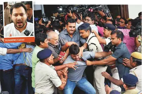  ?? PTI ?? Bihar Deputy Chief Minister Tejashwi Yadav’s security team manhandles journalist­s at an event in Patna yesterday.
