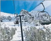  ?? Christophe­r Weber Associated Press ?? SKIERS go up a lift at Mammoth Mountain on Friday. The Sierra Nevada snowpack is 106% of average.