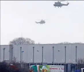  ??  ?? Tension: Police helicopter­s hover over the printworks yesterday