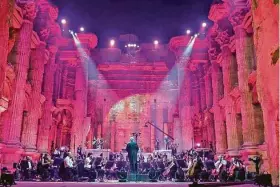  ?? AFP via Getty Images ?? Maestro Harout Fazlian conducts rehearsals inside the Temple of Bacchus at the historic site of Baalbek in Lebanon’s eastern Bekaa Valley on Saturday.