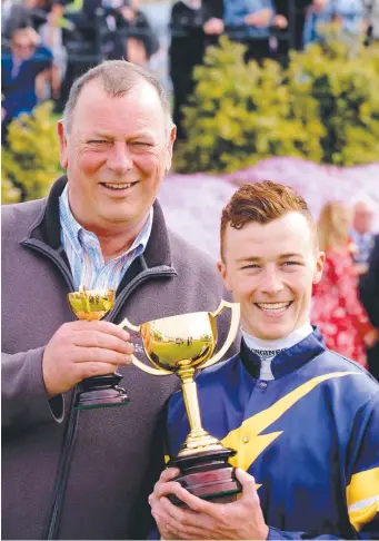  ??  ?? Trainer Michael Moroney and jockey Patrick Moloney after the Cup win. Picture: MARK WILSON