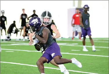  ?? Penny Chanler/Special to News-Times ?? Hauling it in: El Dorado junior DeAndra Burns, Jr., catches a pass in 7-on-7 competitio­n over the summer at EHS. Burns will be one of the featured players in the Wildcats' talented receiving corps.