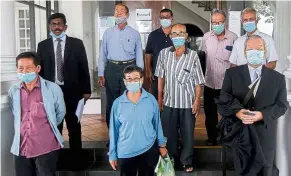  ??  ?? At a loss: Farmers from Chemor with their lawyers leaving the courthouse. Their lawyers said they would be filing for a stay on the order.