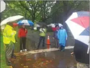  ?? BILL RETTEW JR. – DIGITAL FIRST MEDIA ?? About a dozen West Chester residents and borough staffers discuss stormwater runoff during a downpour last week.