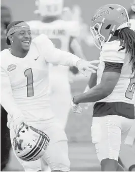  ??  ?? American Team defensive back Joshuah Bledsoe of Missouri (1) celebrates a play with defensive back Shawn Davis of Florida on Saturday at the Senior Bowl Rusty Costanza/ AP